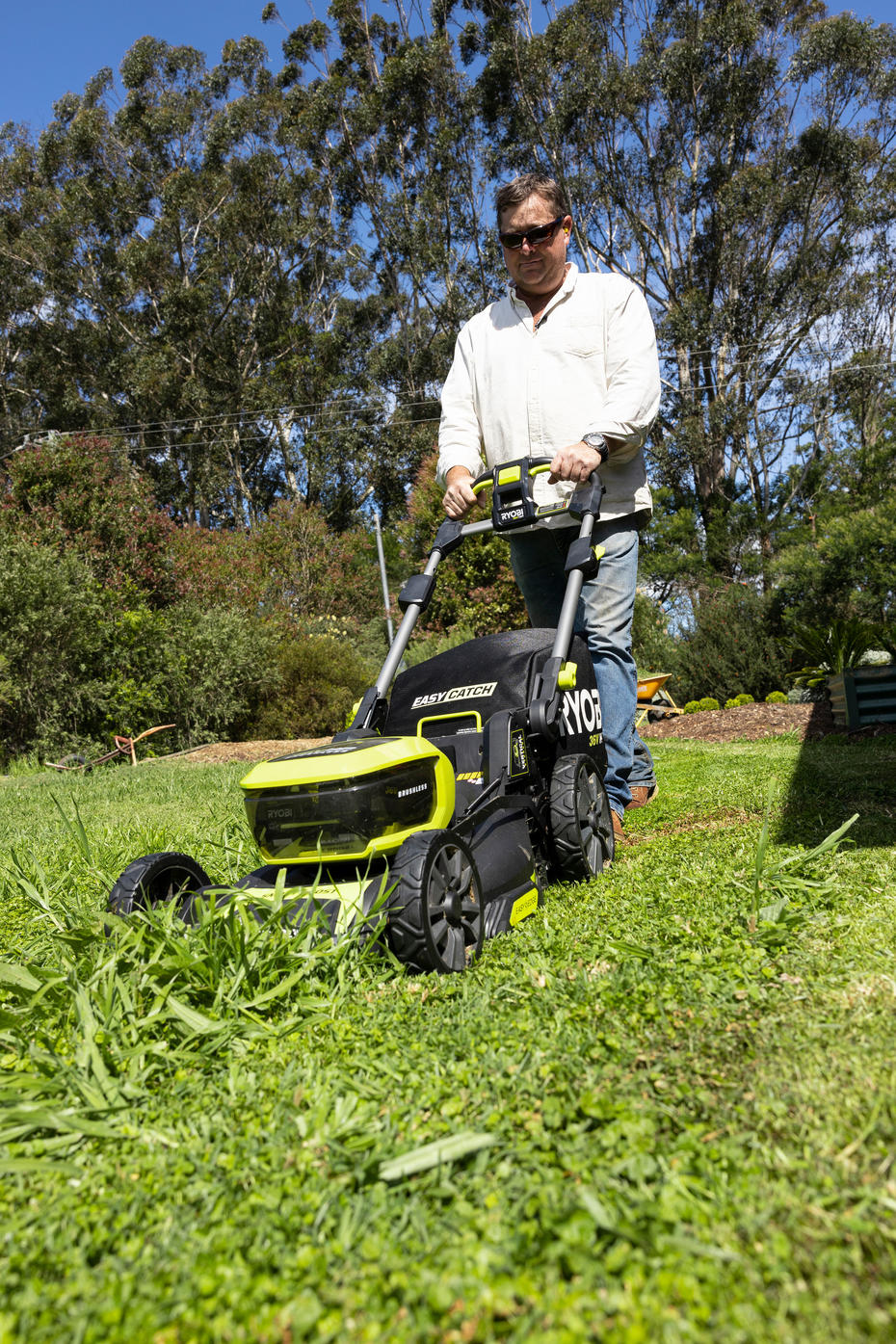 Jason Hodges uses a 36V lawn mower to cut long grass
