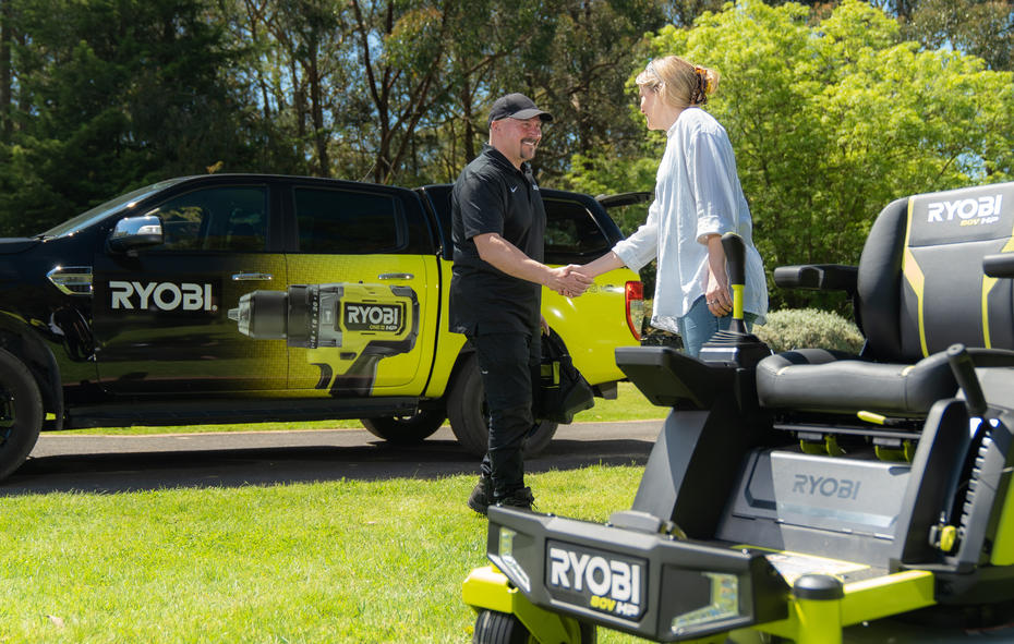 RYOBI RXT support team member shaking hands with a customer who has purchased an 80V Ride-on Mower