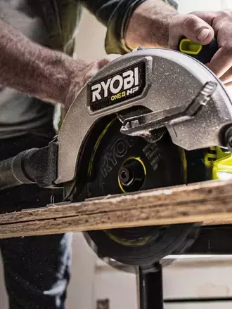 Close up of RYOBI saw cutting plank of wood