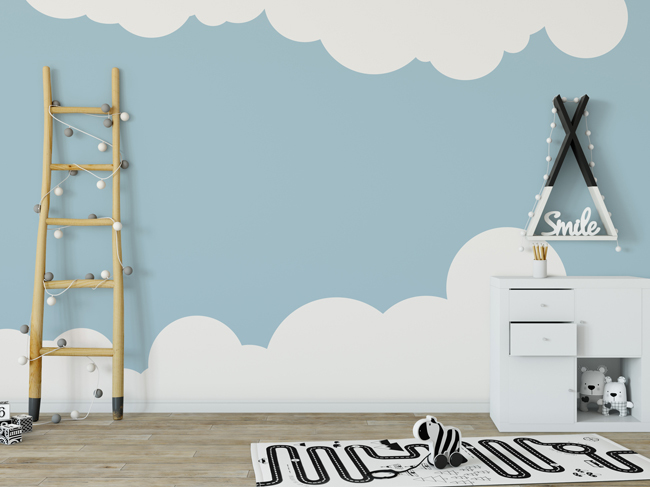 A light blue wall with white clouds painted along the top and bottom. A white storage unit and timber lean-to sit in front. 