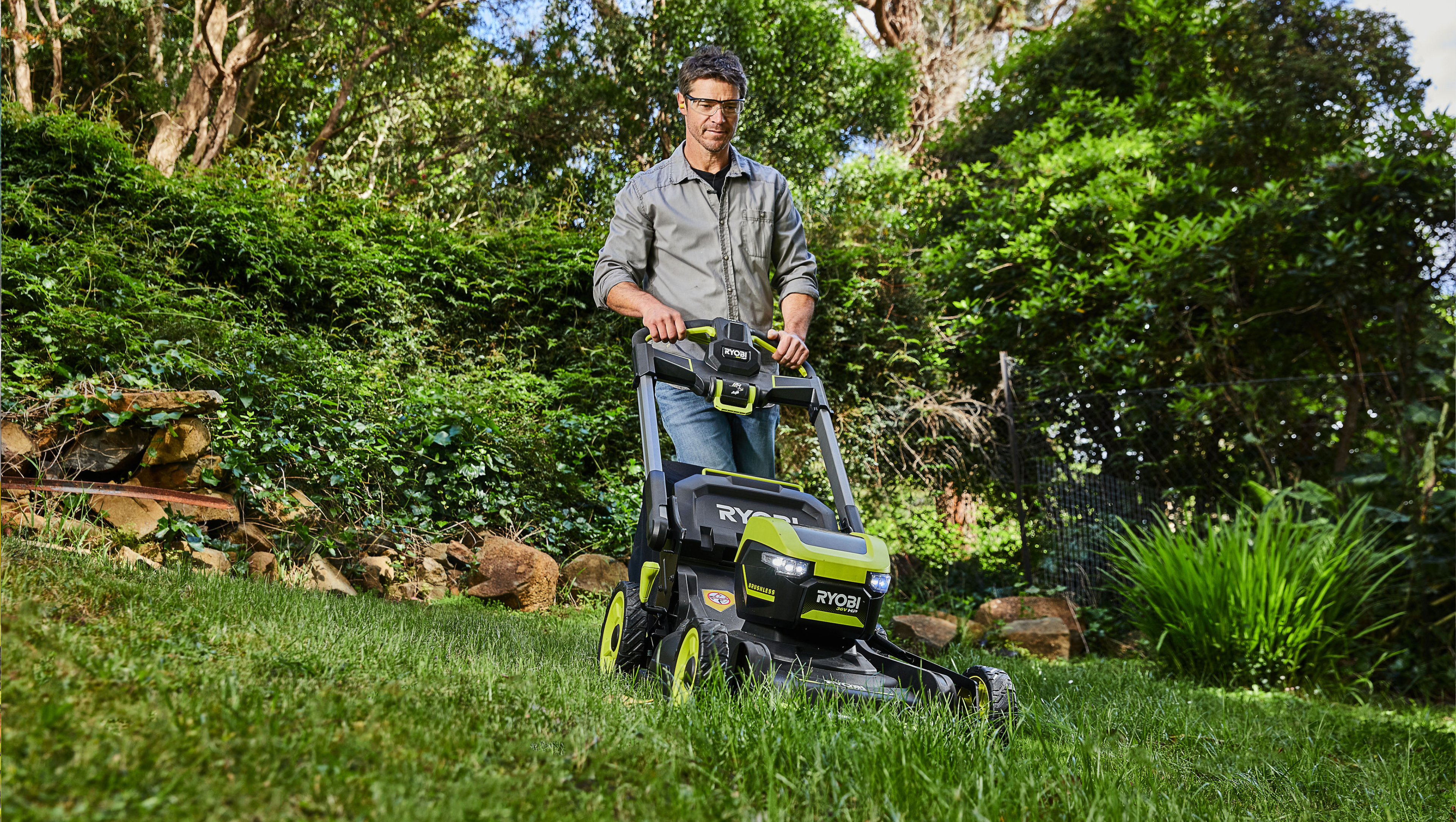 RYOBI 36V HP™ Brushless 53cm Self-Propelled Lawn Mower 6Ah Kit mowing a lush backyard lawn