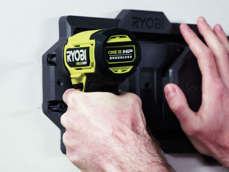 Close up of RYOBI power drill drilling into wall hall for LINK storage system.. 