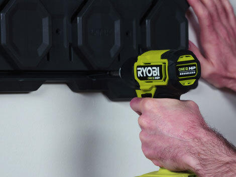Close up of drilling into LINK storage system wall hole with RYOBI drill.