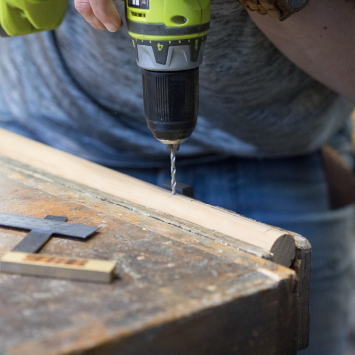 Drilling holes in the dowel with a Ryobi drill driver