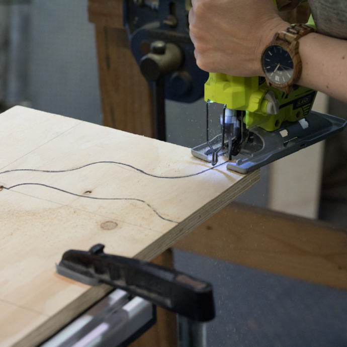 A Ryobi jigsaw being used to cut stand legs